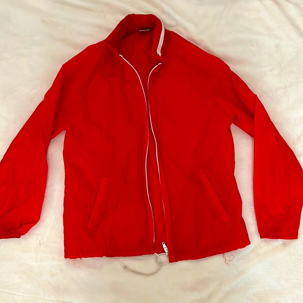 Red windbreaker.